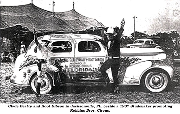 Clyde Beatty and Hoot Gibson in Jacksonville, FL beside a 1937 Studebaker promoting Robbins Bros. Circus.