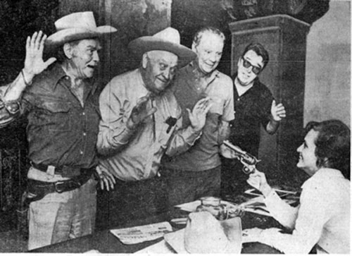 Mrs. M. P. Smith of Nashville, TN, holds a gun on Don “Red” Barry, Max “Alibi” Terhune, Russ ”Lucky” Hayden and Lash LaRue at the first Memphis Film Festival in 1972.