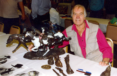 George Montgomery poses beside some of his bronze sculptures at an April 1993 Beverly Garland Hotel autograph show in North Hollywood, CA.