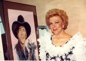 Virginia Vale poses beside a portrait of her favorite co-star George O’Brien at the August 1991 Golden Boot Awards.