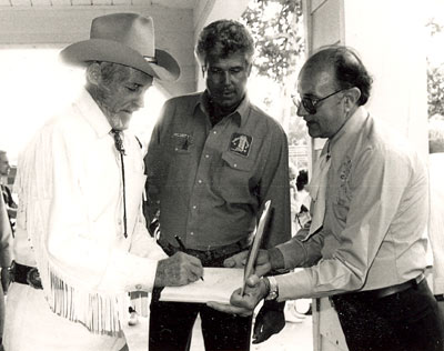 Guy Madison signs an autograph for a fan at the Golden Boot Awards in 1986