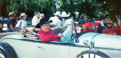 Ben Johnson (red shirt) and Pierce Lyden (black outfit) get ready for the annual parade at the Toulumne County, Sonora, California, Wild West Film Fest in 1991. WC’s Boyd and Donna Magers and Virginia Vale are directly behind and to the left of Ben.
