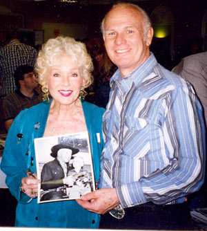 Grace Bradley Boyd with Gary Gray who holds a very young picture of he and William Boyd (Hopalong Cassidy). Taken at one of the Ray Courts memorabilia shows in North Hollywood, California.