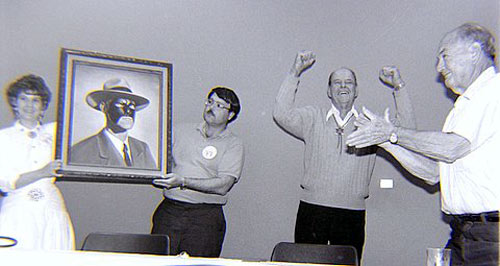 Bonnie Boyd and the artist unveil a portrait of Tom Steele as Republic’s Masked Marvel at the Knoxville 1990 Western Film Fair. Steele was overjoyed with the painting as director William Witney applauds. (Thanx to Grady Franklin.)