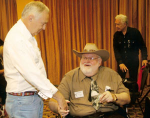 Boyd Magers presents a $100 first prize to Trivia Contest winner Larry McLane, who also receives a free one year subscription to WESTERN CLIPPINGS.