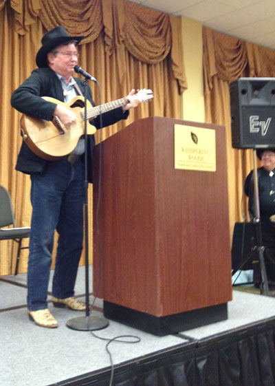 At the banquet Randy Boone sings a song about a grizzly bear especially requested by James Drury. Festival co-sponsor Ray Nielsen watches from the side.