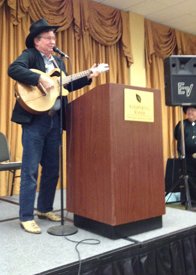 At the banquet Randy Boone sings a song about a grizzly bear especially requested by James Drury. Festival co-sponsor Ray Nielsen watches from the side.