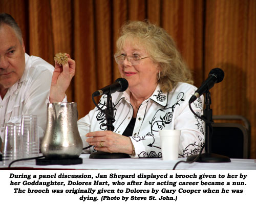 During a panel discussion, Jan Shepard displayed a brooch given to her by her Goddaughter, Dolores Hart, who after her acting career became a nun. The brooch was originally given to Dolores by Gary Cooper when he was dying. (Photo by Steve St. John.)