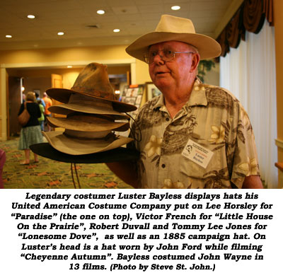 Legendary costumer Luster Bayless displays hats his United American Costume Company put on Lee Horsley for "Paradise" (the one on top), Victor French for "Little House on the Prairie", Robert Duvall and Tommy Lee Jones for "Lonesome Dove", as well as an 1885 campaign hat. On Luster's head is as hat worn by John Ford while filming "Cheyenne Autumn". Bayless costumed John Wayne in 13 films.  (Photo by Steve St. John.)