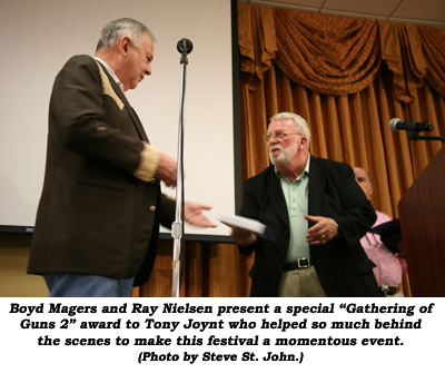 Boyd Magers and Ray Nielsen present a special "Gathering of Guns 2" award to Tony Joynt who helped so much behind the scenes to make this festival a monentous event.  (Photo by Steve St. John.)