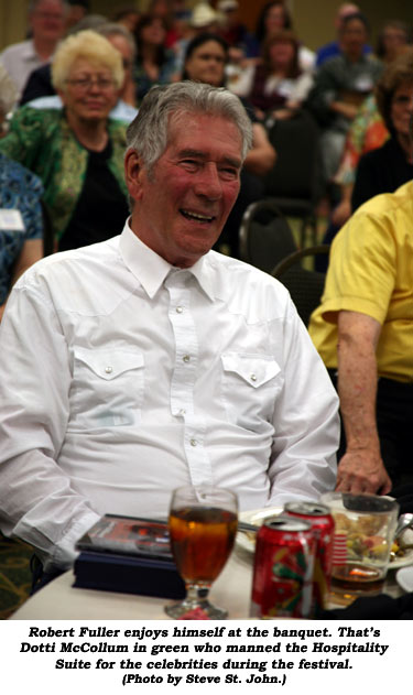 Robert Fuller enjoys himself at the banquet. That's Dotti McCollum in green who manned the Hospitality Suite for the celebrities during the festival.  (Photo by Steve St. John.)
