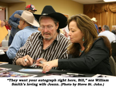"They want your autograph right here, Bill," sez William Smith's loving wife Joann.  (Photo by Steve St. John.)