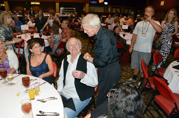 Robert Conrad visits the table of Henry and Lauren Darrow at the Saturday night banquet.