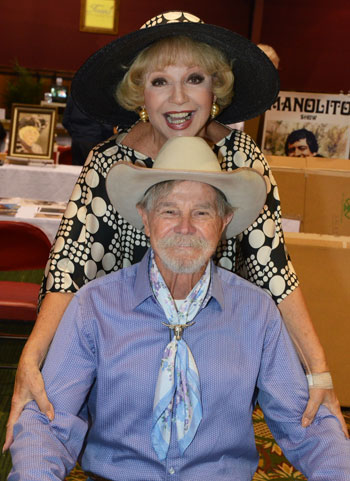 Ruta Lee and Buck Taylor strike a pose for the camera.