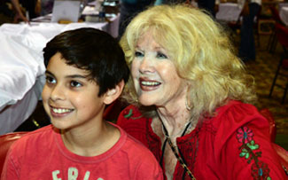 Connie Stevens poses with a young fan.