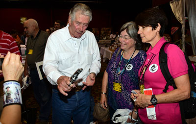 Bob Fuller explains how to handle a six-gun to two of his fan club members.