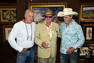 Jeff Osterhage, Luster Bayless and Buck Taylor stand in front of some of Buck’s gorgeous artwork. 