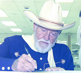 Bob Allen, star of Columbia's Ranger series, signs autographs at the Raleigh, NC, 1989 Western Film Fair. (Photo courtesy Grady Franklin.)