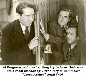 Al Ferguson and another thug try to force their way into a room blocked by Victor Jory in Columbia's "Green Archer" serial ('40).