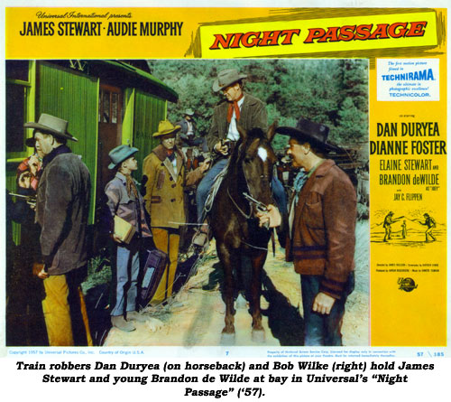 Train robbers Dan Duryea (on horseback) and Bob Wilke (right) hold James Stewart and young Brandon de Wilde at bay in Universal's "Night Passage" ('57).