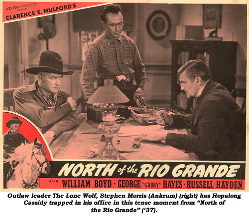 Outlaw leader The Lone Wolf, Stephen Morris (Ankrum) (right) has Hopalong Cassidy trapped in his office in this tense moment from "North of the Rio Grande" ('37).