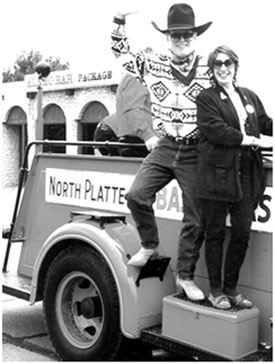 Will Hutchins and wife Barbara on the fire engine, waving.