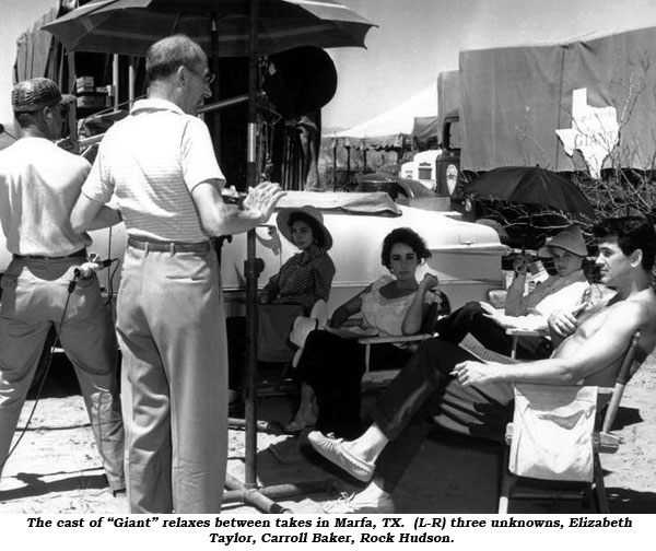 The cast of "Giant" relaxes between takes in Marfa, TX. (L-R) three unknowns, Elizabeth Taylor, Carroll Baker, Rock Hudson.
