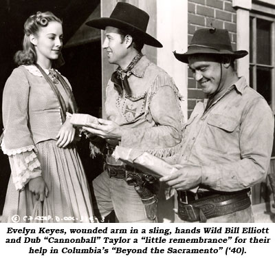 Evelyn Keyes, wounded arm in a sling, hands Wild Bill Elliott and Dub "Cannonball" Taylor a "little remembrance" for their help in Columbia's "Beyond the Sacramento" ('40).