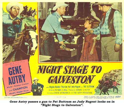Gene Autry passes a gun to Pat Buttram as Judy Nugent looks on on this "Night Stage to Galveston" lobby card.