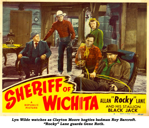 Lyn Wilde watches as Clayton Moore hogties badman Roy Barcroft. "Rocky" Lane guards Gene Roth In "Sheriff of Wichita".