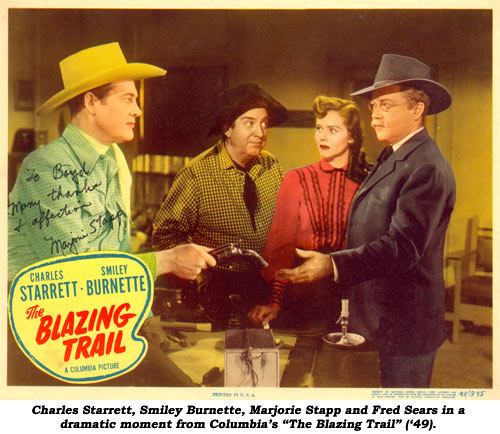Charles Starrett, Smiley Burnette, Marjorie Stapp and Fred Sears in a dramatic moment from Columbia's "The Blazing Trail".