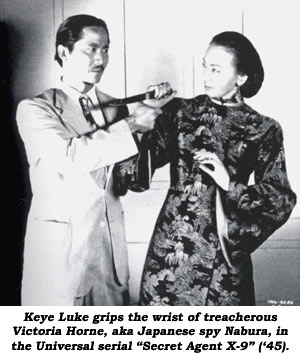 Keye Luke grips the wrist of treacherous Victoria Horne, aka Japanese spy Nabura in the Universal serial "Secret Agent X-9" ('45).