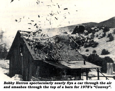 Bobby Herron spectacularly nearly flys a car through the air and smashes through the top of a barn in 1978's "Convoy".