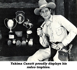 Yakima Canutt proudly displays his rodeo trophies.