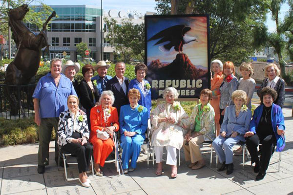 A group of 17 Republic alumni gathered on August 18, 2010, to unveil the Republic 75th Anniversary sign at CBS Studio Center (the old Republic lot on Radford Ave. in Studio City). Front row seated (L to R): Anne Jeffreys, Ann Rutherford, Joan Leslie, Adrian Booth, Coleen Gray, Shirley Mitchell, Jane Withers. Back row standing (L to R): Hugh O’Brian, Ben Cooper, Majorie Lord, Dick Jones, Tommy Cook, Donna Martell, Marsha Hunt, Eilene Janssen, Anna Maria Alberghetti, Jane Kean.