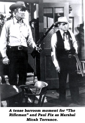 "A tense barroom moment for "The Rifleman" and Paul Fix as Marshal Micah Torrance.