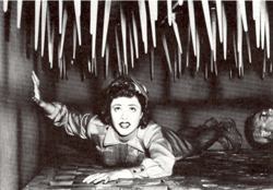 Scene from serial showing Nyoka about to be killed by huge spikes as floor rises toward the spikes.