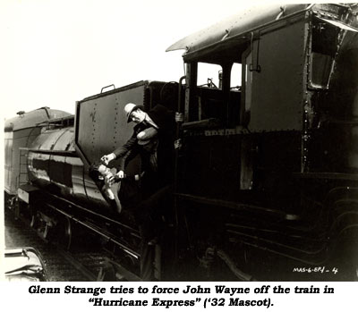 Glenn Strange tries to force John Wayne off the train in "Hurricane Express" ('32 Mascot).
