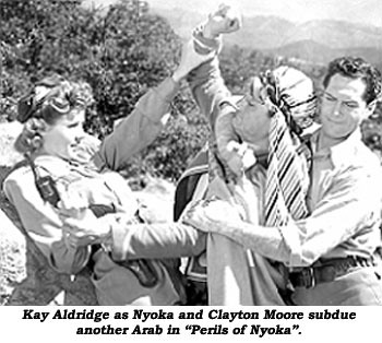 Kay Aldridge as Nyoka and Clayton Moore subdue another Arab in "Perils of Nyoka".
