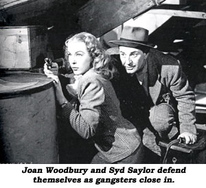 Joan Woodbury and Syd Saylor defend themselves as gangsters close in.