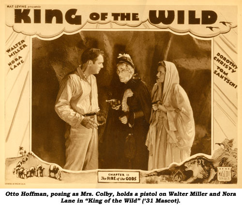 Otto Hoffman, posing as Mrs. Colby, holds a pistol on Walter Miller and Nora Lane in "King of the Wild" ('31 Mascot).