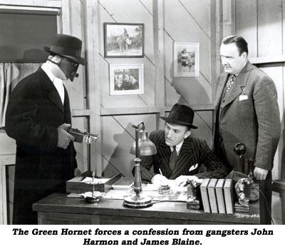 The Green Hornet forces a confession from gangsters John and James Blaine.