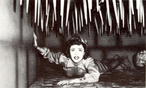 Kay Aldridge as Nyoka about to be killed by knives coming down from ceiling.