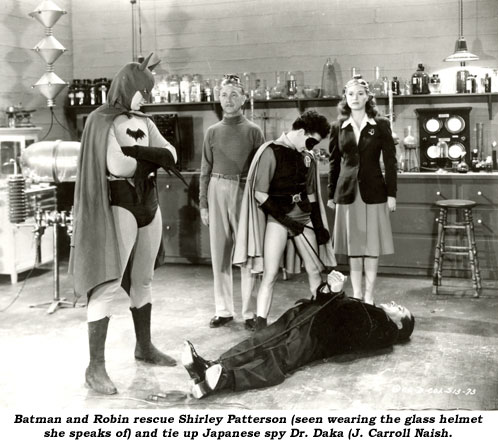 Batman and Robin rescue Shirley Patterson (seen wearing the glass helmet she speaks of) and tie up Japanese spy Dr. Daka (J. Carroll Naish).