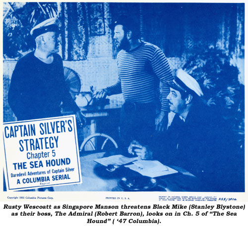 Rusty Wescoatt as Singapore Manson threatens Black Mike (Stanley Blystone) as their boss, The Admiral (Robert Barron, looks on in Ch. 5 of "The Sea Hound" ('47 Columbia).
