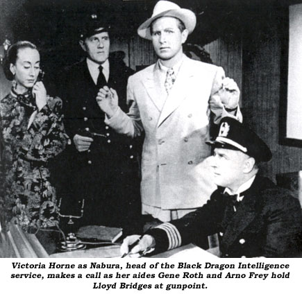 Victoria Horne as Nabura, head of the Black Dragon Intelligence service, makes a call as her aides Gene Roth and Arno Frey hold Lloyd Bridges at gunpoint.