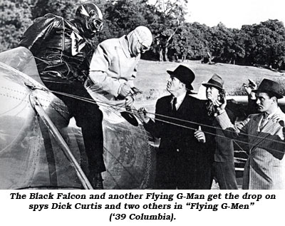 The Black Falcon and another Flying G-Man get the drop on spys Dick Curtis and two others in "Flyiung G-Men" ('39 Columbia).