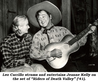 Leo Carrillo strums his guitar and entertains Jeanne Kelly on the set of "Riders of Death Valley" ('41).