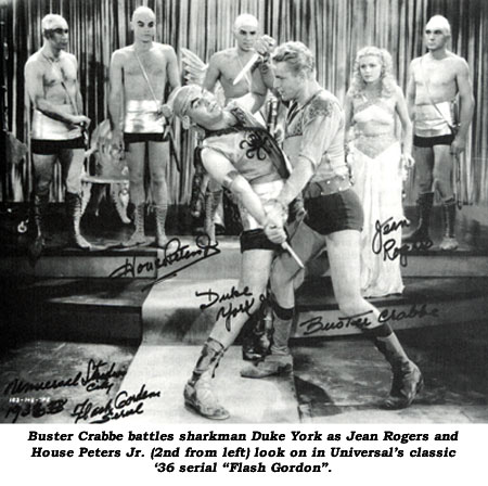 Buster Crabbe battles sharkman Duke York as Jean Rogers and House Peters Jr. (2nd from left) look on in Universal's classic '36 serial "Flash Gordon".