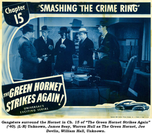 Gangsters surround the Hornet in Ch. 15 of "The Green Hornet Strikes Again" ('40). (L-R) Unknown, James Seay, Warren Hull as The Green Hornet, Joe Devlin, William Hall, Unknown.